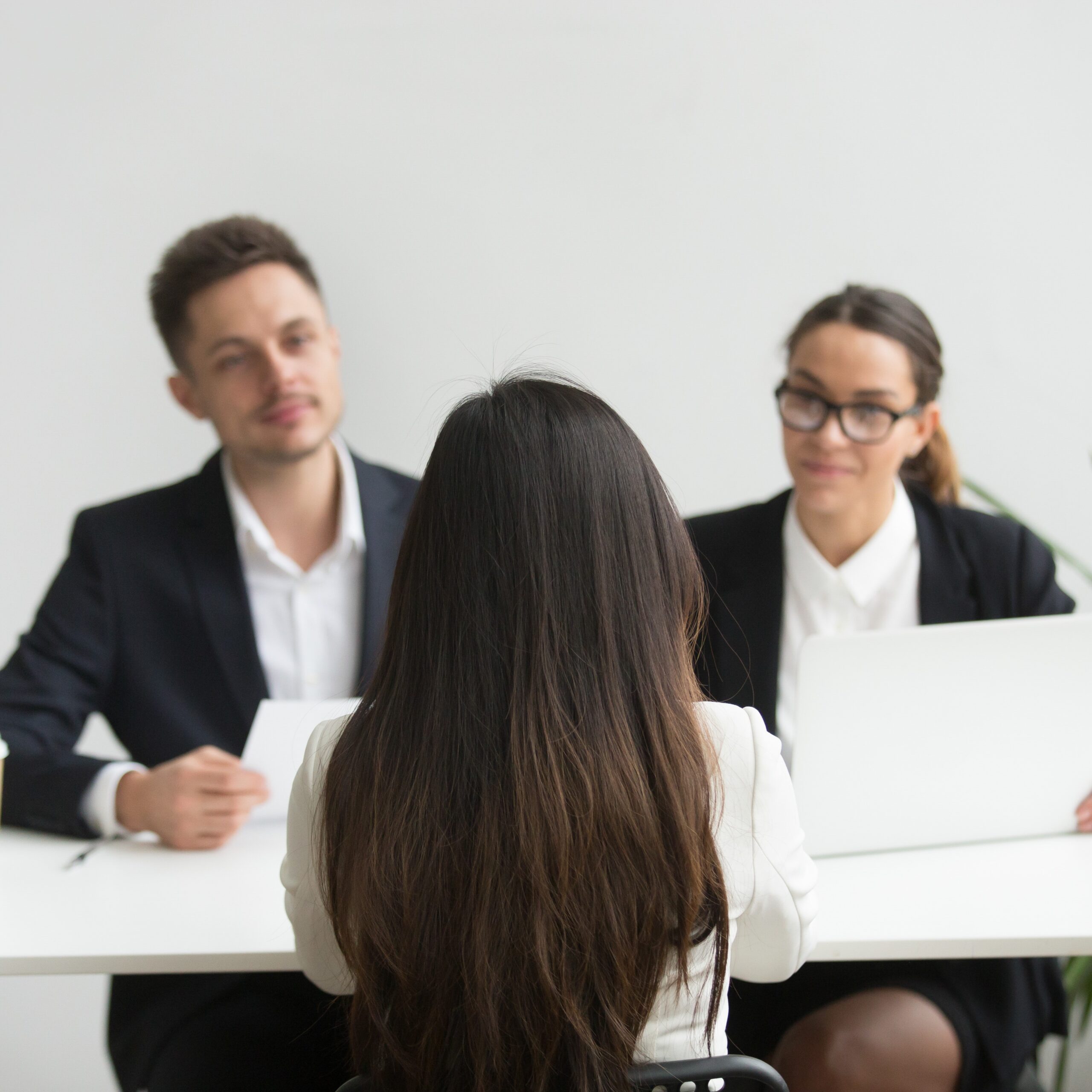 Headhunters interviewing female job candidate